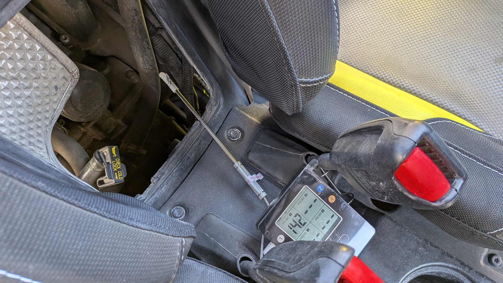 ThermoPro TP25 controller reading 142°F with the probe moved into the engine bay